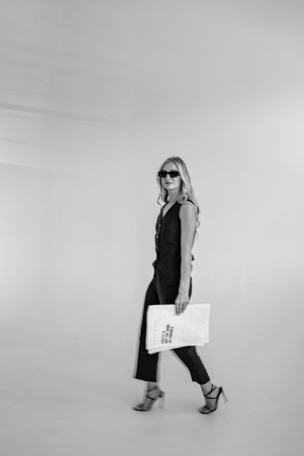 Sabrina mid-stride with the Salt and Sage newspaper, Denver web design studio