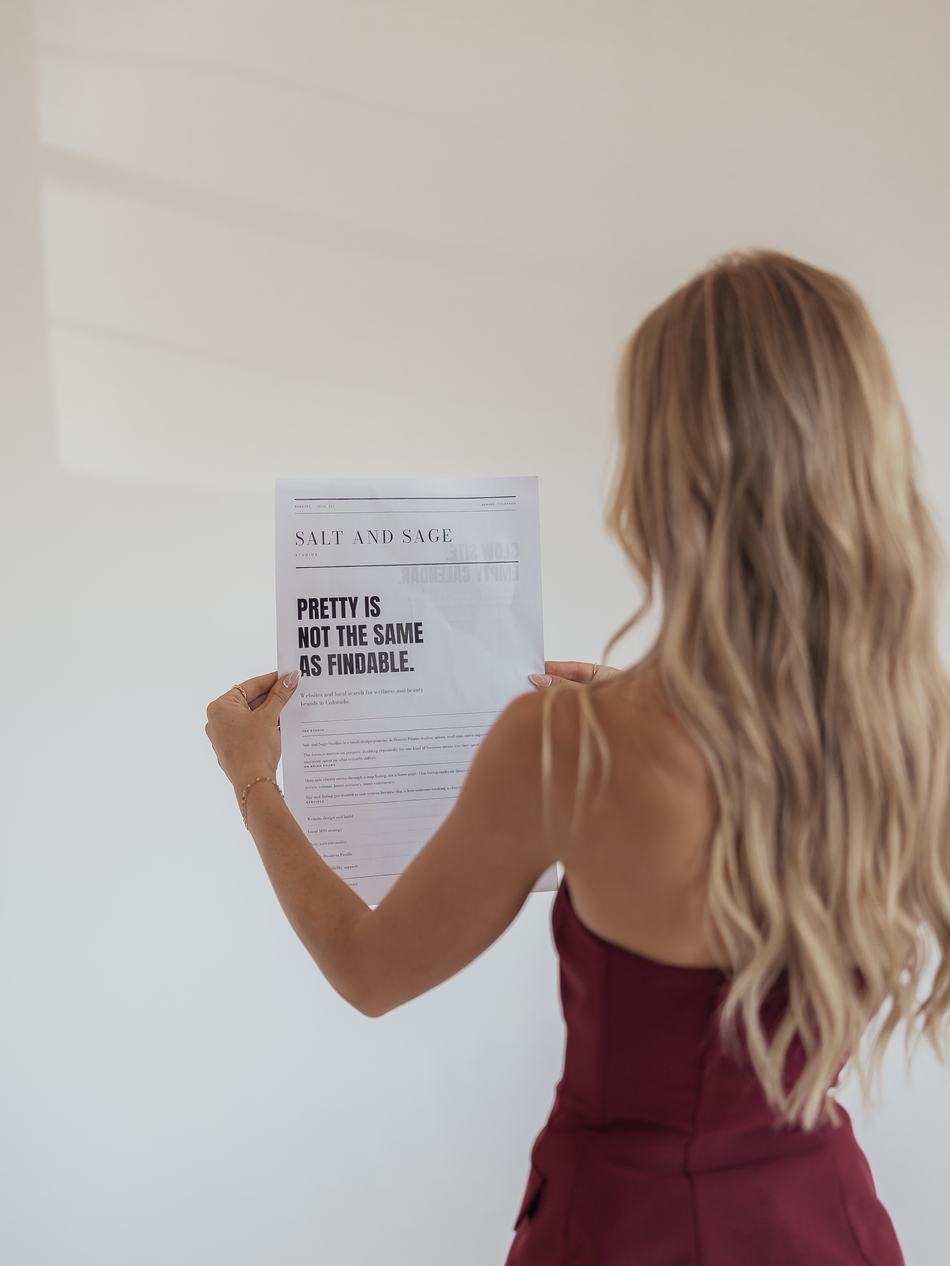 Sabrina Cunningham reading the Salt and Sage Studios newspaper