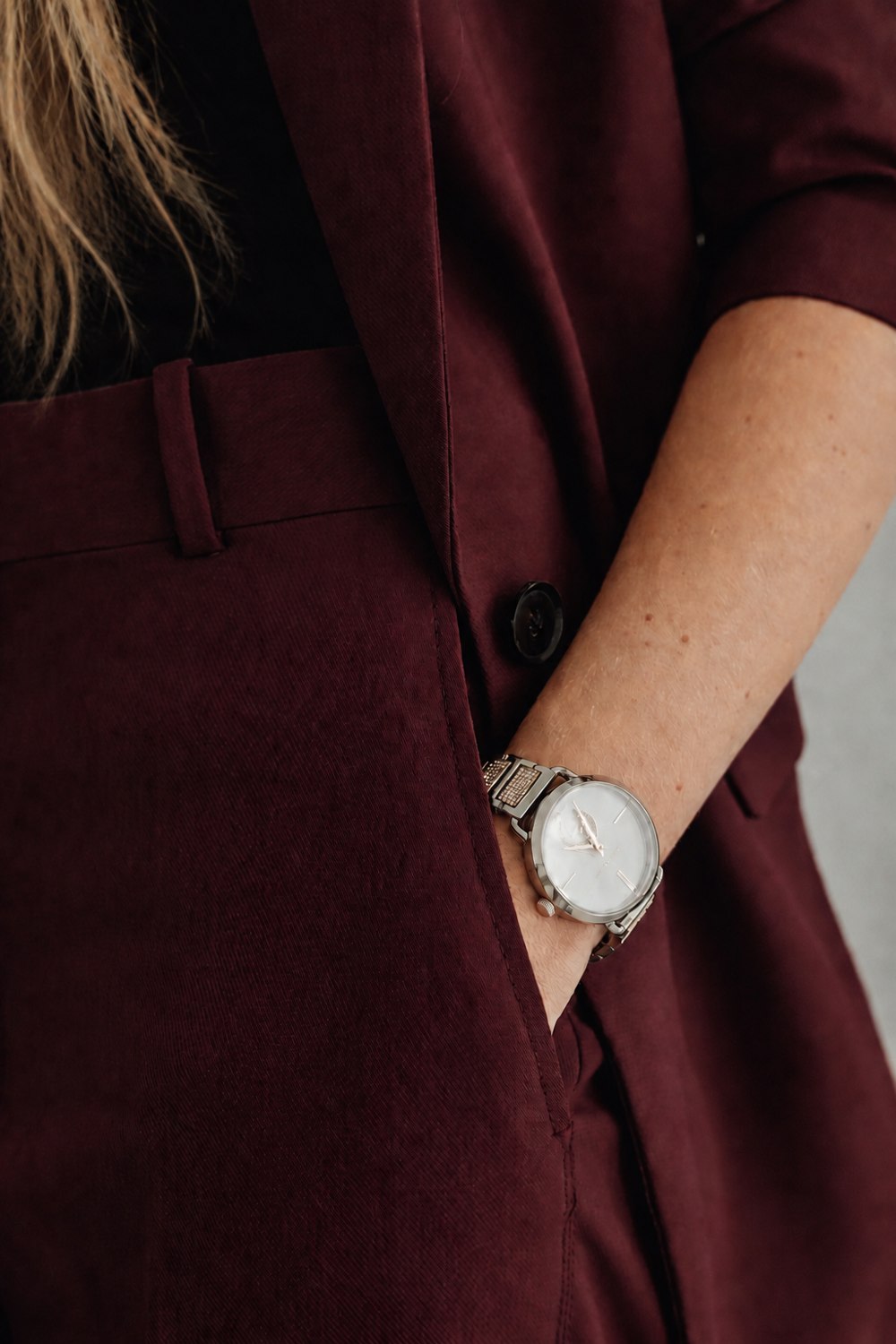 A wine suit sleeve and gold watch, the editorial detail Salt and Sage brings to Denver websites